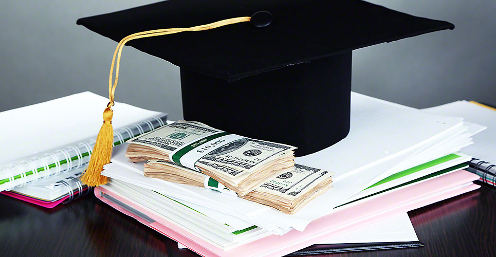 Money for graduation or training on wooden table on grey backgro