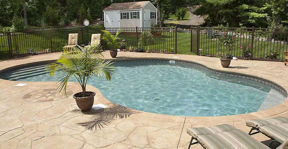 Lush backyard swimming pool and patio space.