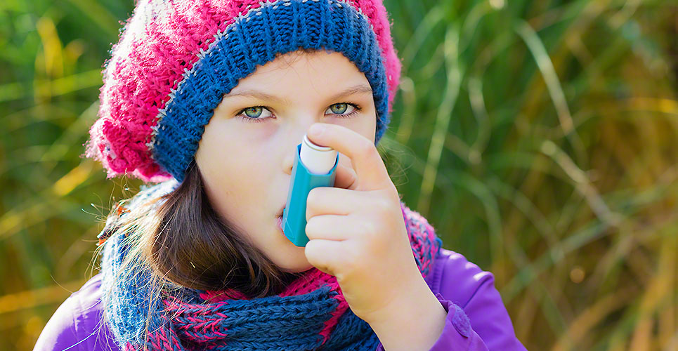 Girl Using Asthma Inhaler on an autumn day