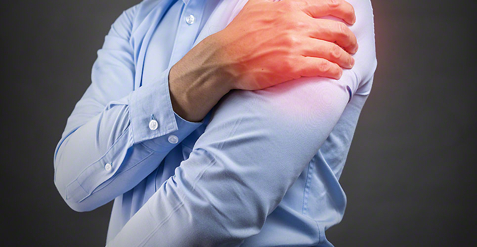 man holding his shoulder in pain