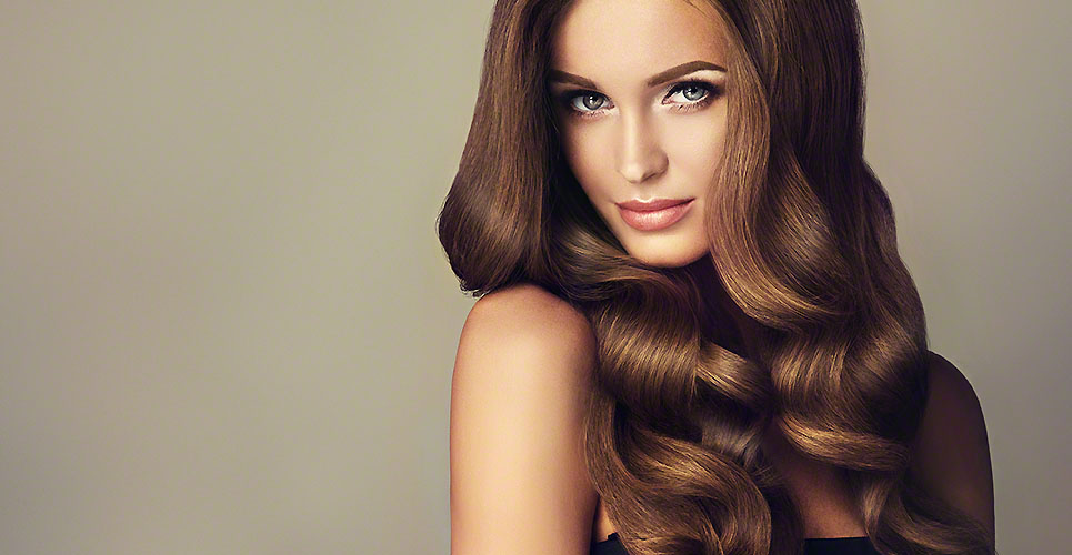 Young, brown haired beautiful model with long, wavy,well groomed hair.